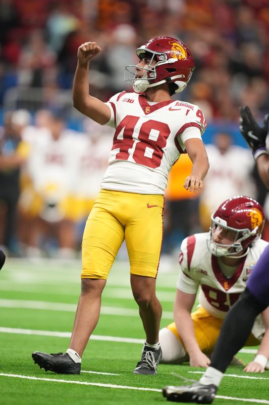 Dec 30, 2025; San Antonio, TX, USA; Southern California Trojans punter Ryon Sayeri (48) kicks a 22-yard fielg goal in overtime against the TCU Horned Frogs during the Alamo Bowl at Alamodome. Mandatory Credit: Kirby Lee-Imagn Images