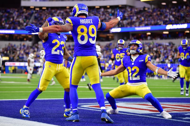 Jan 4, 2026; Inglewood, California, USA; Los Angeles Rams tight end Tyler Higbee (89) reacts with running back Kyren Williams (23) and wide receiver Puka Nacua (12) after scoring a touchdown against the Arizona Cardinals during the second half at SoFi Stadium. Mandatory Credit: Gary A. Vasquez-Imagn Images