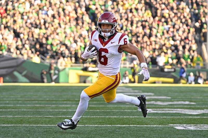 Nov 22, 2025; Eugene, Oregon, USA; Southern California Trojans wide receiver Makai Lemon (6) runs with the ball during the first half against the Oregon Ducks at Autzen Stadium. Mandatory Credit: Troy Wayrynen-Imagn Images