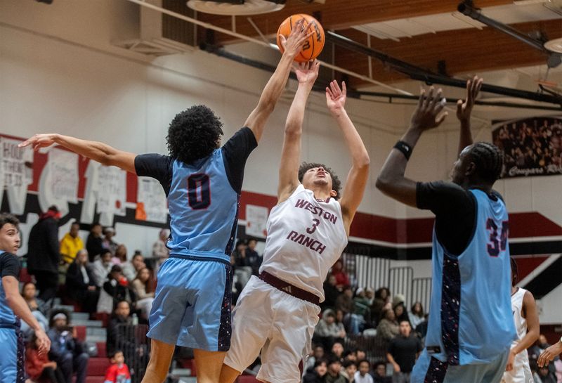 Weston Ranch’s Romello Bruhn, right, goes to the hoop against Destiny Christian Academy’s Frederick Blue III, left, and Djibi Camara during a boys varsity basketball game at Weston Ranch in Stockton on Jan. 9, 2026. Weston Ranch 72-71.