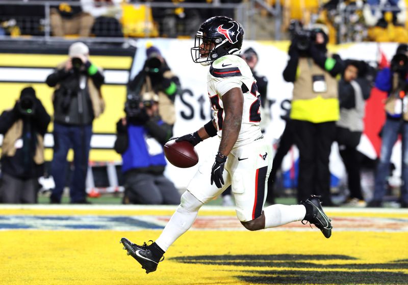 Jan 12, 2026; Pittsburgh, PA, USA; Houston Texans running back Woody Marks (27) scores a touchdown during the second half of an AFC Wild Card Round game against the Pittsburgh Steelers at Acrisure Stadium. Mandatory Credit: Charles LeClaire-Imagn Images