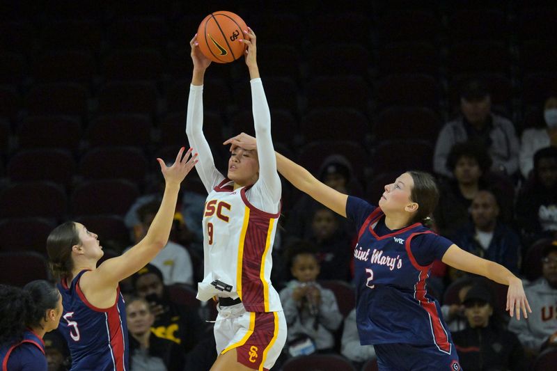 Dec 2, 2025; Los Angeles, California, USA; Saint Mary's Gaels forward Abigail Shoff (5) and guard Amy Kurkowski (2) defend USC Trojans guard Jazzy Davidson (9) during the first half at Galen Center. Mandatory Credit: Jayne Kamin-Oncea-Imagn Images