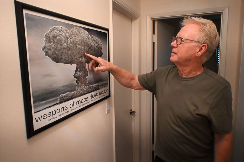 Dr. Robert Dodge shows the tiny AK-47s that create a mushroom cloud in this artwork on Jan. 15, 2026. Dodge, now retired as a physician, is an anti-nuclear weapon activist.