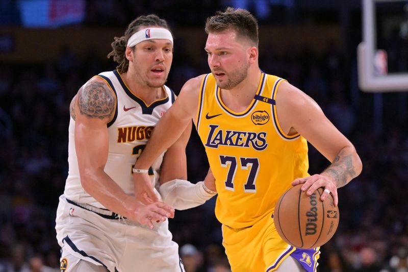 Mar 19, 2025; Los Angeles, California, USA; Los Angeles Lakers guard Luka Doncic (77) is guarded by Denver Nuggets forward Aaron Gordon (32) in the first half at Crypto.com Arena. Mandatory Credit: Jayne Kamin-Oncea-Imagn Images