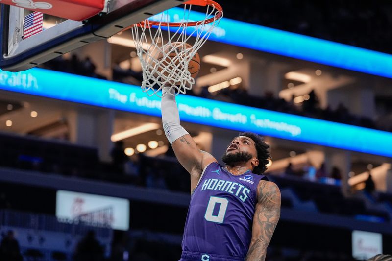 Dec 12, 2025; Charlotte, North Carolina, USA; Charlotte Hornets forward Miles Bridges (0) slam dunks against the Chicago Bulls during the first quarter at Spectrum Center. Mandatory Credit: Jim Dedmon-Imagn Images