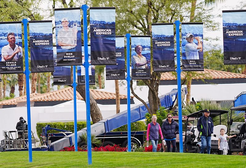 Spectators walk amongst banners of previous winners of the American Express at the Nicklaus Tournament Course at PGA West in La Quinta, Calif,. January 21, 2026.