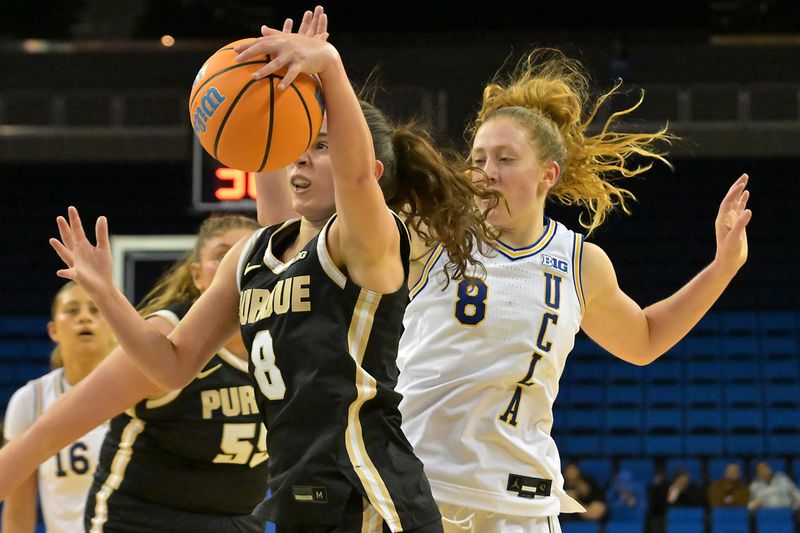 Jan 21, 2026; Los Angeles, California, USA; Purdue Boilermakers guard Hila Karsh (8) and UCLA Bruins guard Gianna Kneepkens (8) go for a rebound in the first half at Pauley Pavilion presented by Wescom Financial. Mandatory Credit: Jayne Kamin-Oncea-Imagn Images