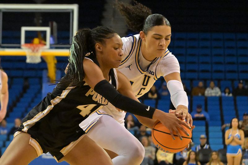 Jan 21, 2026; Los Angeles, California, USA; Purdue Boilermakers guard Tara Daye (44) and UCLA Bruins center Lauren Betts (51) reach for a loose ball in the first half at Pauley Pavilion presented by Wescom Financial. Mandatory Credit: Jayne Kamin-Oncea-Imagn Images