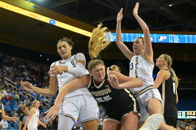 Jan 21, 2026; Los Angeles, California, USA; UCLA Bruins center Lauren Betts (51), forward Amanda Muse (33) and Purdue Boilermakers forward Avery Gordon (55) go for a rebound in the first half at Pauley Pavilion presented by Wescom Financial. Mandatory Credit: Jayne Kamin-Oncea-Imagn Images