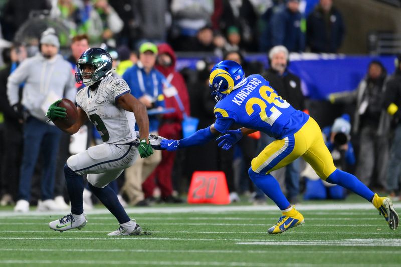 Dec 18, 2025; Seattle, Washington, USA; Seattle Seahawks running back Kenneth Walker III (9) runs against Los Angeles Rams safety Kamren Kinchens (26) in the first half at Lumen Field. Mandatory Credit: Steven Bisig-Imagn Images