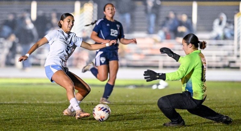 Redwood’s Miranda Ortiz takes shot against El Diamante goalie Melissa Ruiz in East Yosemite League high school girls soccer Friday, January 23, 2026.