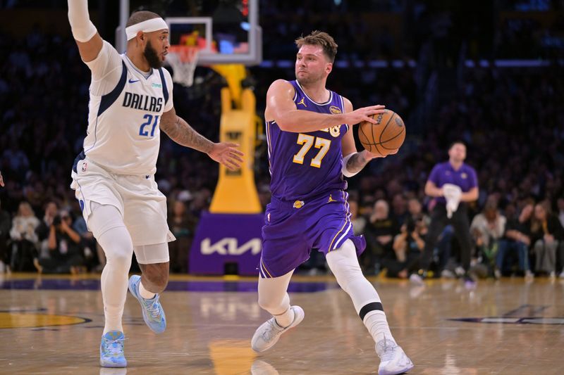 Nov 28, 2025; Los Angeles, California, USA; Los Angeles Lakers guard Luka Doncic (77) is defended by Dallas Mavericks forward Daniel Gafford (21) as he drives to the basket in the first half at Crypto.com Arena. Mandatory Credit: Jayne Kamin-Oncea-Imagn Images