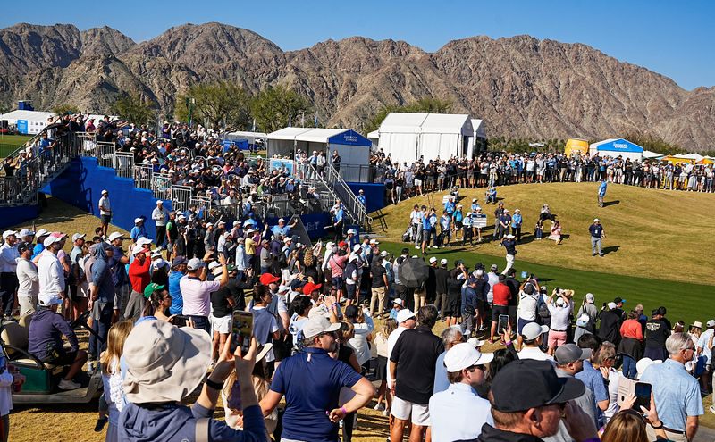 A large gallery watches Scottie Scheffler tee off on the first hole during the third round of the American Express on the Stadium Course at PGA West in La Quinta, Calif., January 24, 2026.
