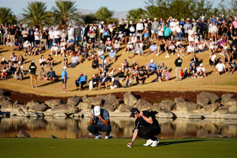 Si Woo Kim reacts as Blades Brown sets to putt on Stadium Course 18th green during the final round of The American Express golf tournament at PGA West in La Quinta, Calif., on Sunday, Jan. 25, 2026.