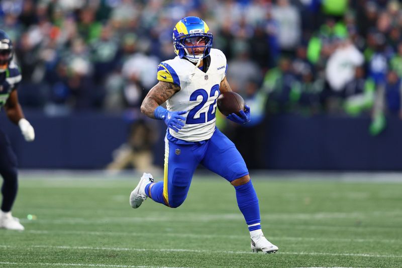 Jan 25, 2026; Seattle, WA, USA; Los Angeles Rams running back Blake Corum (22) runs against the Seattle Seahawks during the first half in the 2026 NFC Championship Game at Lumen Field. Mandatory Credit: Kevin Ng-Imagn Images