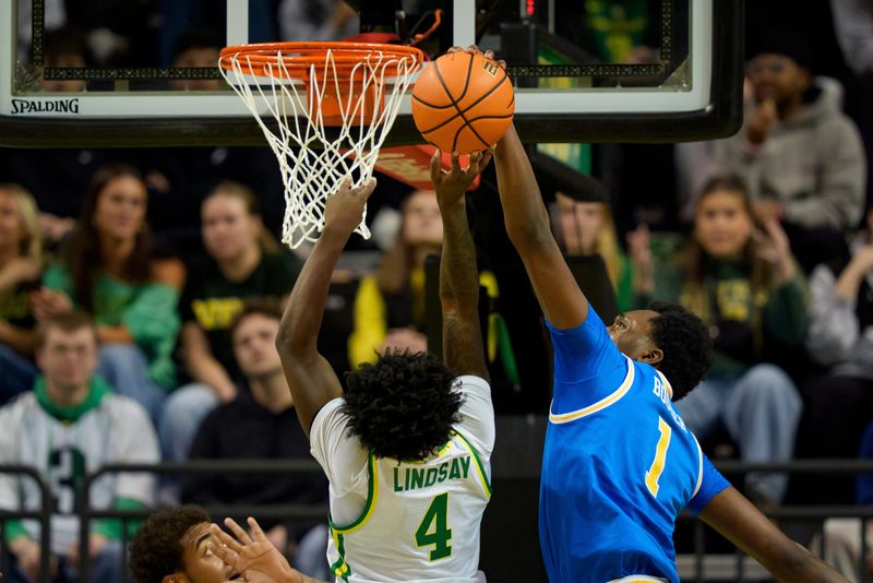 UCLA center Xavier Booker, right, blocks a shot by Oregon forward Dezdrick Lindsay as the Oregon Ducks host the UCLA Bruins on Jan. 28, 2026, at Matthew Knight Arena in Eugene, Oregon.