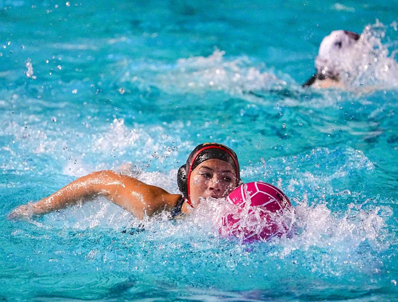 Palm Desert's Jolie Faraci swims with the ball during their match in La Quinta, Calif., Wednesday, Jan. 28, 2026.