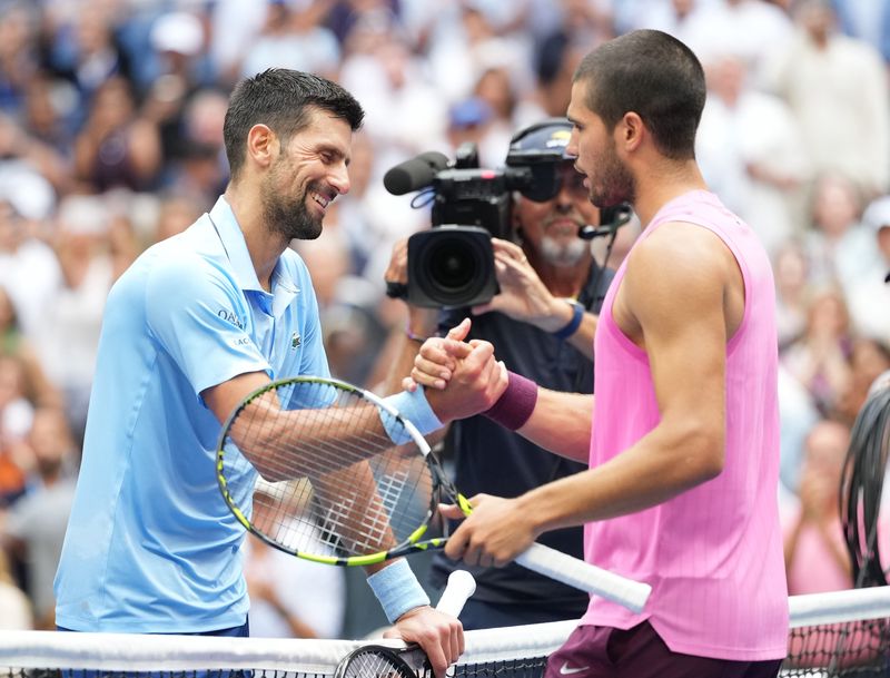 Sep 5, 2025; Flushing, NY, USA;
Carlos Alcaraz (right) (ESP) after beating Novak Djokovic (SRB) (left) on day thirteen of the 2025 U.S. Open tennis tournament at the USTA Billie Jean King National Tennis Center. Mandatory Credit: Robert Deutsch-Imagn Images