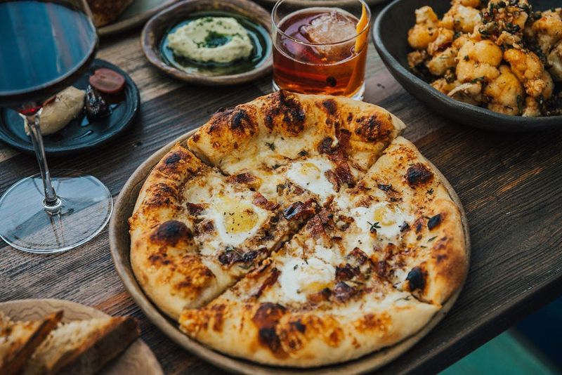 The brunch pizza with bacon, quail eggs, caramelized onions, thyme and fontina at Esther's Kitchen in Las Vegas.