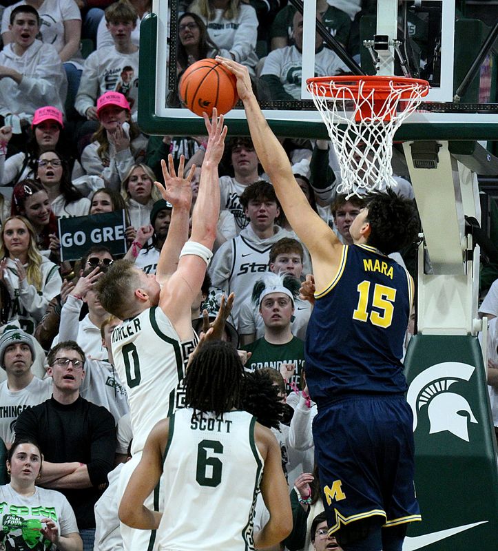 Jan 30, 2026; East Lansing, Michigan, USA; Michigan Wolverines center Aday Mara (15) blocks a shot by Michigan State Spartans forward Jaxon Kohler (0) during the first half at Jack Breslin Student Events Center. Mandatory Credit: Dale Young-Imagn Images