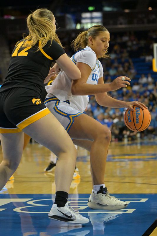 Feb 1, 2026; Los Angeles, California, USA; Iowa Hawkeyes center Layla Hays (12) defends UCLA Bruins forward Sienna Betts (16) in the first half at Pauley Pavilion presented by Wescom Financial. Mandatory Credit: Jayne Kamin-Oncea-Imagn Images