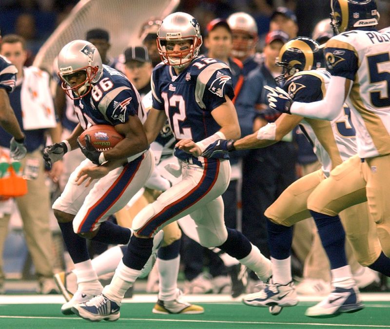 ORG XMIT: 02/03/02 -- SUPERBOWL SUNDAY in New Orleans, LA. The New England Patriots vs the St. Louis Rams -- Tom Brady hands the ball to David Patten in the 3rd quarter of Super Bowl XXXLVI. photo by Bob Breidenbach