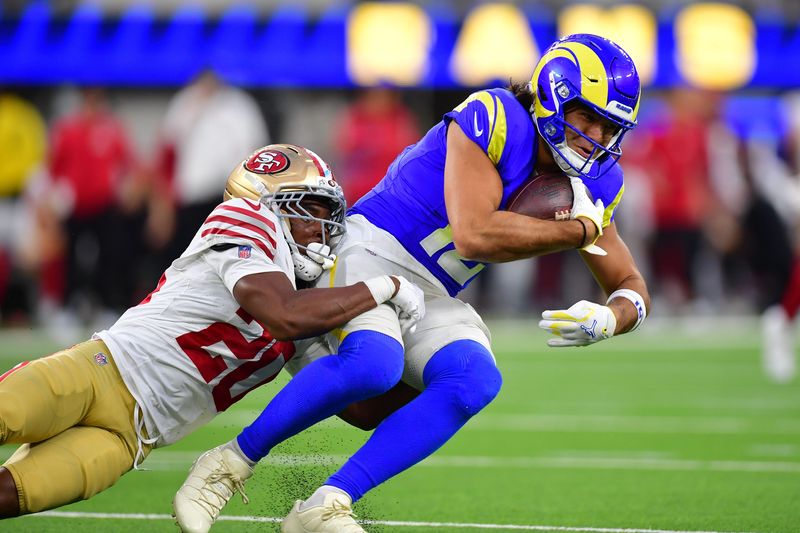 Oct 2, 2025; Inglewood, California, USA; Los Angeles Rams wide receiver Puka Nacua (12) makes a catch against San Francisco 49ers cornerback Upton Stout (20) during the first half at SoFi Stadium. Mandatory Credit: Gary A. Vasquez-Imagn Images