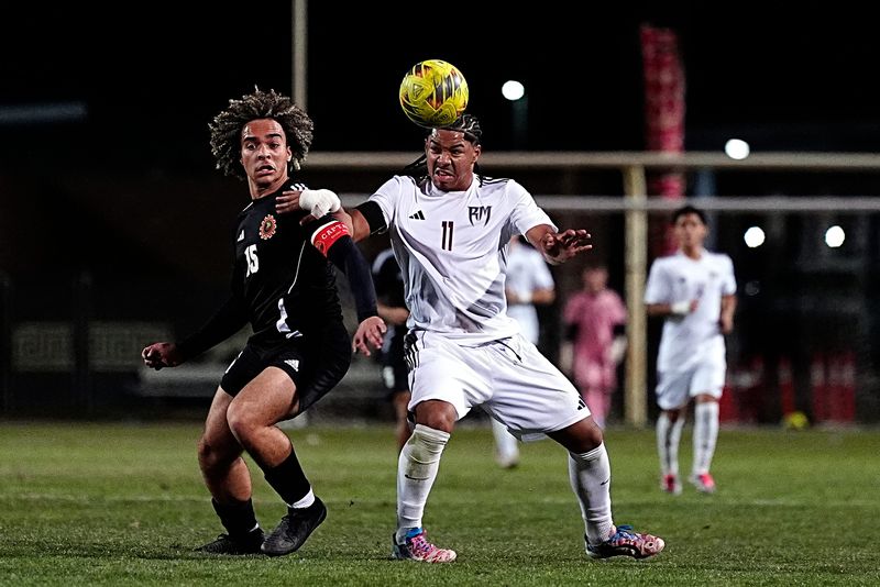Palm Desert defender Elijah Bishop (15), left, and Rancho Mirage forward Jerome Carter (11) battle for the ball in Palm Desert, Calif., on Tuesday, Feb. 3, 2026.