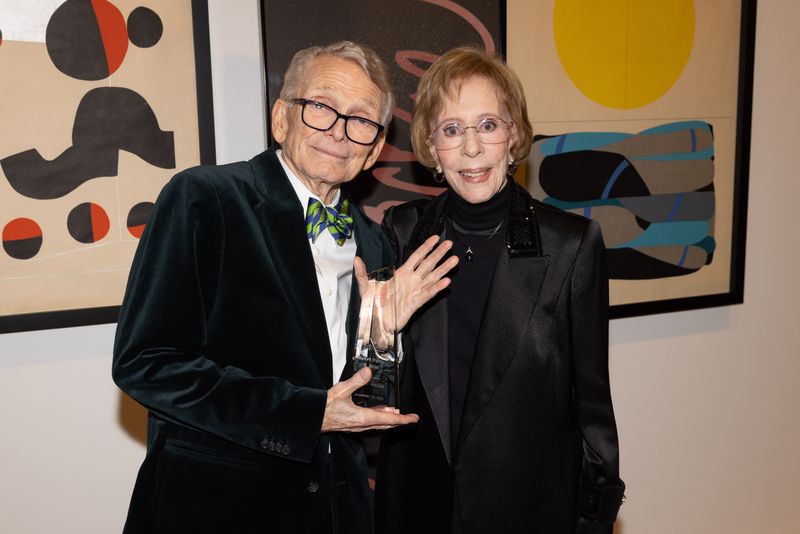 Bob Mackie, with Carol Burnett, shows off his Art Party Award.