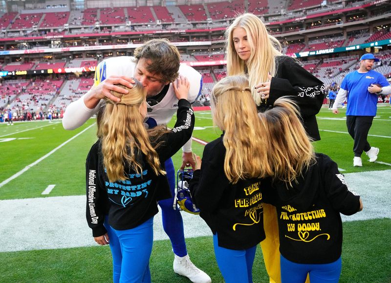 Los Angeles Rams quarterback Matthew Stafford (9) kisses his daughters before playing the Arizona Cardinals at State Farm Stadium on Dec 7, 2025, in Glendale, Ariz.