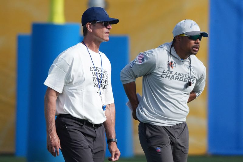 aJul 25, 2025; El Segundo, CA, USA; Los Angeles Chargers coach Jim Harbaugh (left) and passing game coordinator Marcus Brady during training camp at The Bolt. Mandatory Credit: Kirby Lee-Imagn Images