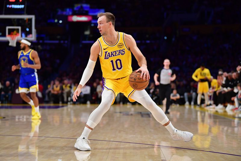 Feb 7, 2026; Los Angeles, California, USA; Los Angeles Lakers guard Luke Kennard (10) controls the ball against the Golden State Warriors during the first half at Crypto.com Arena. Mandatory Credit: Gary A. Vasquez-Imagn Images