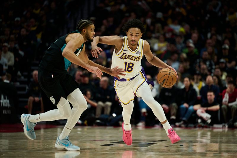 Jan 17, 2026; Portland, Oregon, USA; Los Angeles Lakers guard Kobe Bufkin (18) take the ball up court during the second half against Portland Trail Blazers guard Rayan Rupert (21) at Moda Center. Mandatory Credit: Troy Wayrynen-Imagn Images