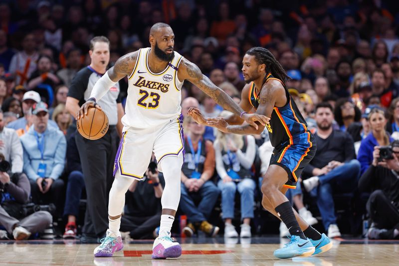 Apr 6, 2025; Oklahoma City, Oklahoma, USA; Los Angeles Lakers forward LeBron James (23) drives against Oklahoma City Thunder guard Cason Wallace (22) during the second half at Paycom Center. Mandatory Credit: Alonzo Adams-Imagn Images