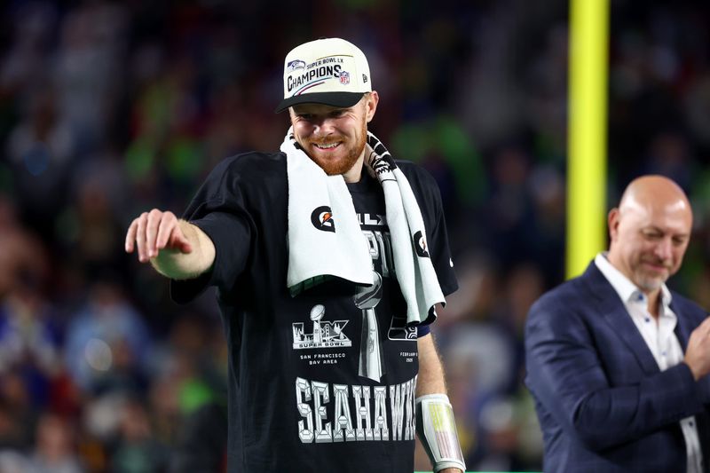 Feb 8, 2026; Santa Clara, CA, USA; Seattle Seahawks quarterback Sam Darnold (14) celebrates on the podium after defeating the New England Patriots in Super Bowl LX at Levi's Stadium. Mandatory Credit: Mark J. Rebilas-Imagn Images