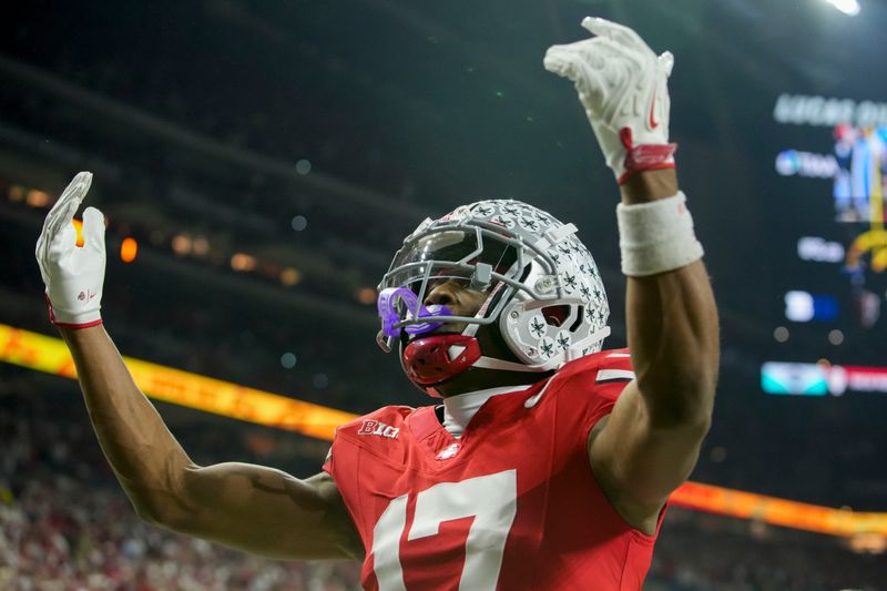Ohio State Buckeyes wide receiver Carnell Tate (17) celebrates a touchdown Saturday, Dec. 6, 2025, during the Big Ten football championship against the Indiana Hoosiers at Lucas Oil Stadium in Indianapolis.