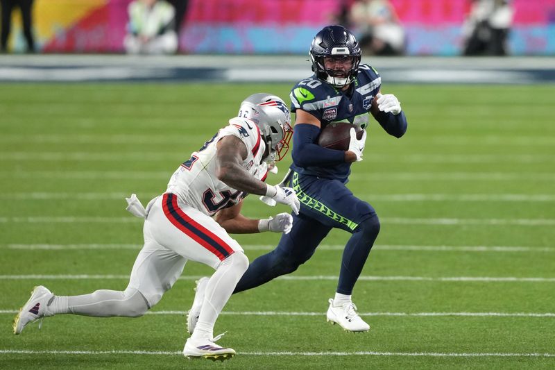 Feb 8, 2026; Santa Clara, CA, USA; Seattle Seahawks safety Julian Love (20) returns an interception against New England Patriots running back Treveyon Henderson (left) during the fourth quarter in Super Bowl LX at Levi's Stadium. Mandatory Credit: Darren Yamashita-Imagn Images