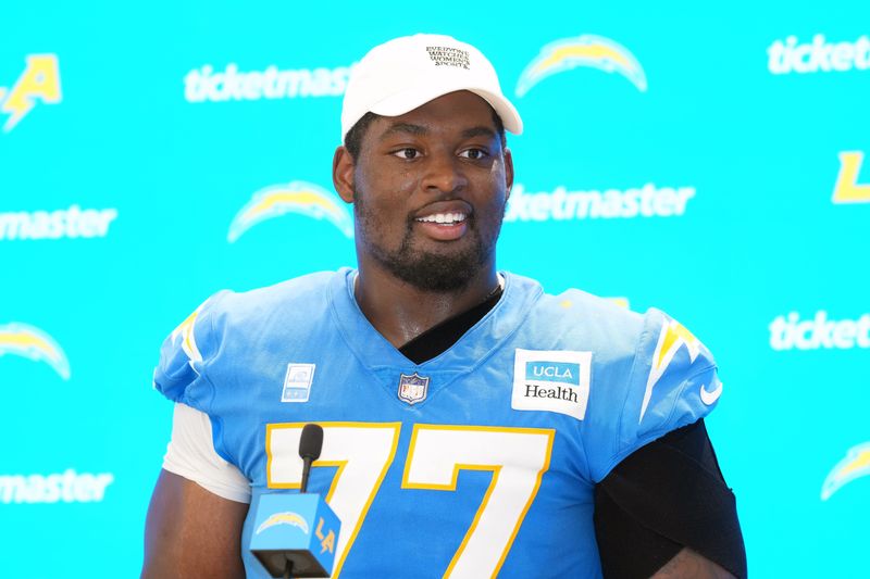 Jul 25, 2025; El Segundo, CA, USA; Los Angeles Chargers guard Zion Johnson (77) during training camp press conference at The Bolt. Mandatory Credit: Kirby Lee-Imagn Images