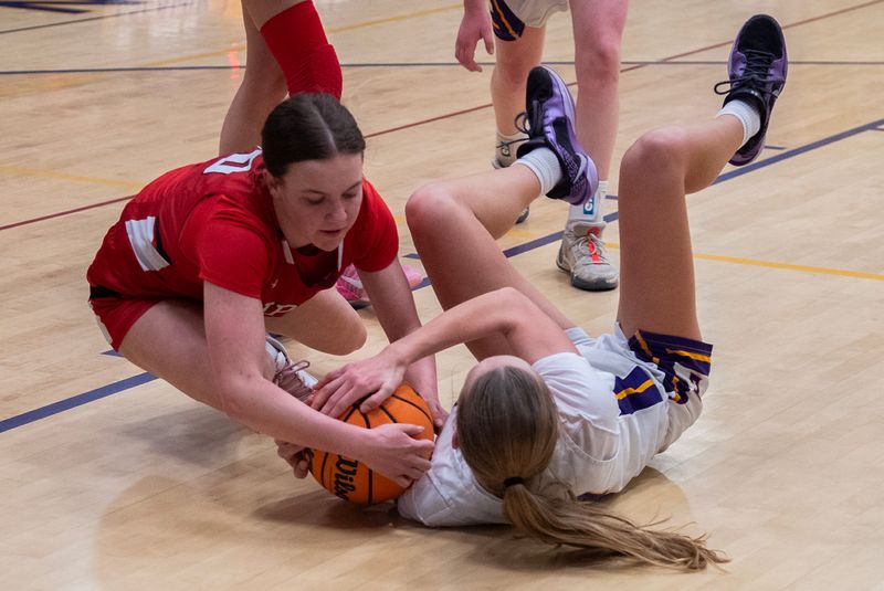 Ripon’s Mckenzie Spear, left, fights for a loose ball with Escalon’s Avery Bartelink during a girls varsity basketball game at Escalon High School Escalon on Feb. 10, 2026. Escalon won 56-33.