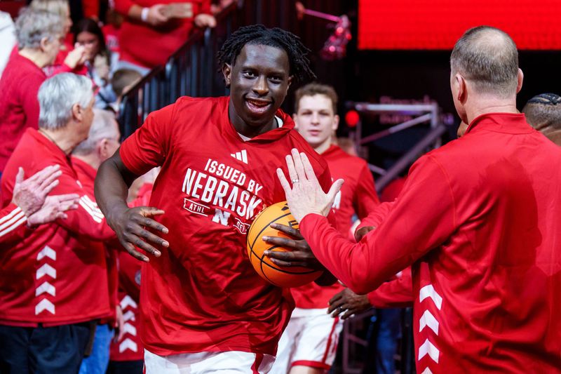 Feb 14, 2026; Lincoln, Nebraska, USA; Nebraska Cornhuskers forward Justin Bolis (7) leads the team onto the court while being greeted by alumni players before the game against the Northwestern Wildcats at Pinnacle Bank Arena. Mandatory Credit: Dylan Widger-Imagn Images