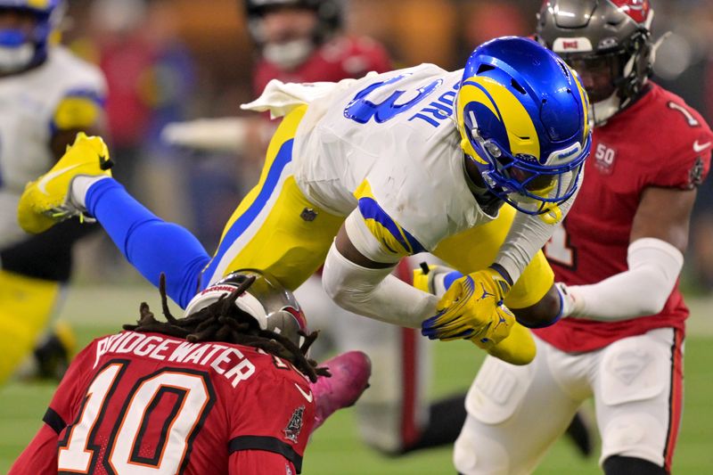 Nov 23, 2025; Inglewood, California, USA; Los Angeles Rams safety Kam Curl (3) leaps over Tampa Bay Buccaneers quarterback Teddy Bridgewater (10) as he is sacked by linebacker Byron Young (0) in the second half at SoFi Stadium. Mandatory Credit: Jayne Kamin-Oncea-Imagn Images