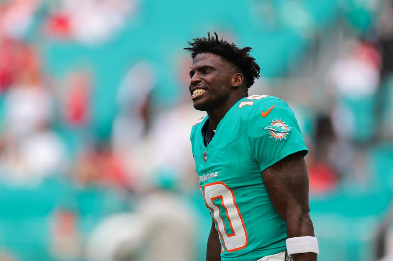 Dec 22, 2024; Miami Gardens, Florida, USA; Miami Dolphins wide receiver Tyreek Hill (10) reacts on the field before the game against the San Francisco 49ers at Hard Rock Stadium. Mandatory Credit: Sam Navarro-Imagn Images