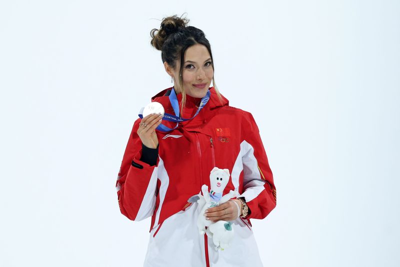 Silver medalist Ailing Eileen Gu of the People's Republic of China celebrates during the medal ceremony for the women's big air final during the Milano Cortina 2026 Olympic Winter Games at Livigno Snow Park.