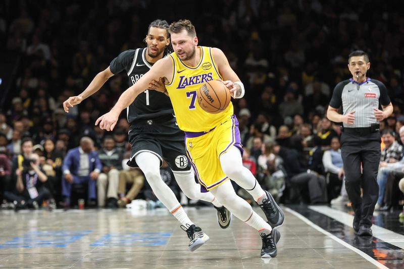 Feb 3, 2026; Brooklyn, New York, USA; Los Angeles Lakers guard Luka Doncic (77) drives past Brooklyn Nets forward Ziaire Williams (1) in the third quarter at Barclays Center. Mandatory Credit: Wendell Cruz-Imagn Images