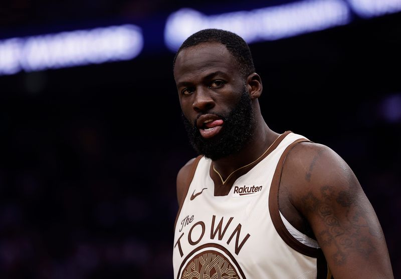 Feb 9, 2026; San Francisco, California, USA; Golden State Warriors forward Draymond Green (23) between plays against the Memphis Grizzlies during the second quarter at Chase Center. Mandatory Credit: Kelley L Cox-Imagn Images