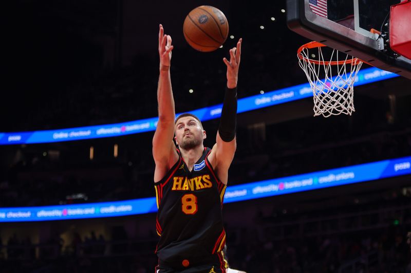 Nov 7, 2025; Atlanta, Georgia, USA; Atlanta Hawks center Kristaps Porzingis (8) grabs a rebound against the Toronto Raptors in the third quarter at State Farm Arena. Mandatory Credit: Brett Davis-Imagn Images
