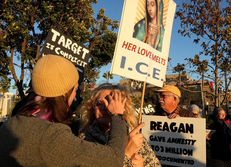 The Rev. Emily Ebert of Holy Trinity Lutheran Church in Thousand Oaks places ashes on Molly de Vries at an Oxnard vigil on Feb. 18 that called on Target to publicly oppose U.S. Immigration and Customs Enforcement actions and violence.