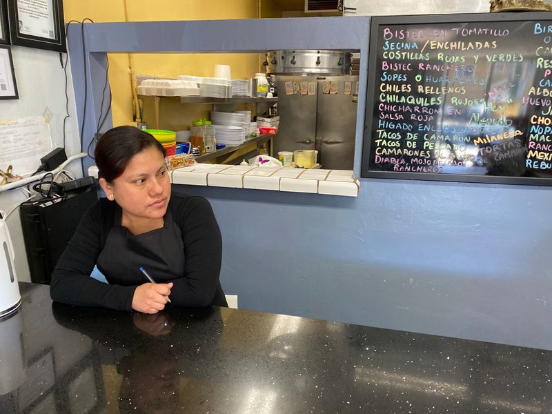 Eliza Solano waits for customers at La Placita Restaurant in Oxnard on Feb. 18. Business slowed down dramatically a year ago when the ongoing immigration enforcement surge began.