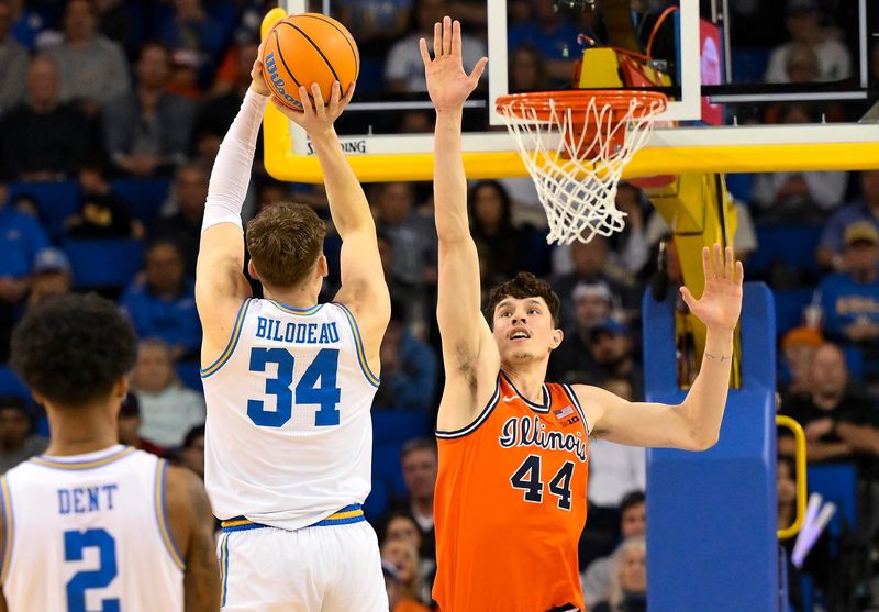 Feb 21, 2026; Los Angeles, California, USA; UCLA forward Tyler Bilodeau (34) shoots over Illinois center Zvonimir Ivisic (44) during the second half at Pauley Pavilion presented by Wescom Financial. Mandatory Credit: Robert Hanashiro-Imagn Images