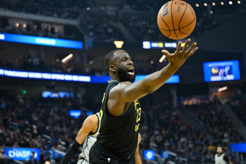 Feb 11, 2026; San Francisco, California, USA; Golden State Warriors forward Draymond Green (23) rebounds against the San Antonio Spurs in the first quarter at Chase Center. Mandatory Credit: Eakin Howard-Imagn Images